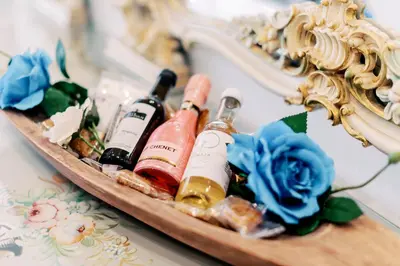 a tray with bottles of wine and a mirror at Adama Luxury Villa in Kremasti
