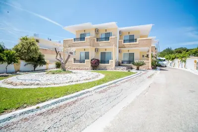 a house on the side of a road at Mosaic Garden Anastasias Rooms in Faliraki