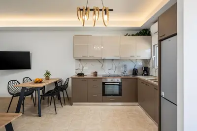 a kitchen with a table and a dining room at Mayas Boutique Greece Rhodes Kremasti in Kremasti