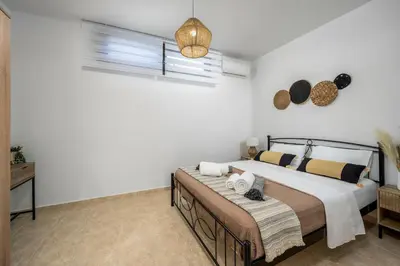 a bedroom with a large bed and a window at Mayas Boutique Greece Rhodes Kremasti in Kremasti