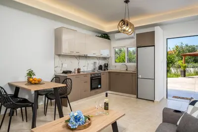 a kitchen and living room with a table and chairs at Mayas Boutique Greece Rhodes Kremasti in Kremasti