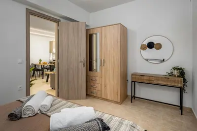 a bedroom with a bed and a wooden cabinet at Mayas Boutique Greece Rhodes Kremasti in Kremasti