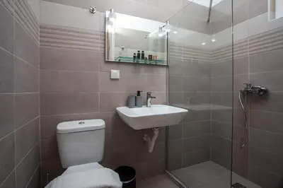 a bathroom with a toilet and a sink and a shower at Bless View Studios in Lachania