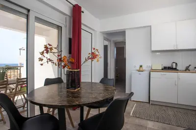 a kitchen and dining room with a table and chairs at Bless View Studios in Lachania