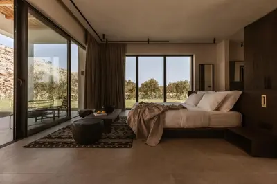 a bedroom with a bed and a large window at Casa Cook Rhodes (Adults Only) in Kolimbia