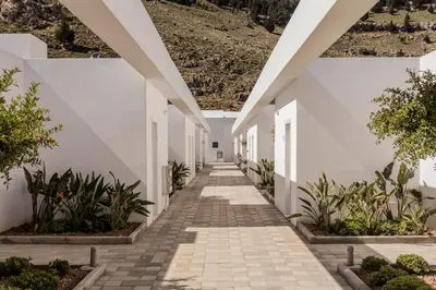 a hallway of a house with white walls and plants at Casa Cook Rhodes (Adults Only) in Kolimbia