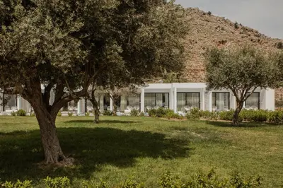 a building with trees in a field of grass at Casa Cook Rhodes (Adults Only) in Kolimbia