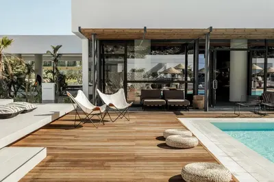 a house with a pool and chairs next to a house at Casa Cook Rhodes (Adults Only) in Kolimbia
