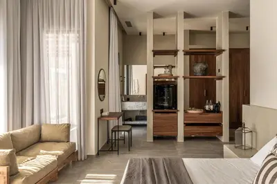 a bedroom with a couch and a living room at Casa Cook Rhodes (Adults Only) in Kolimbia