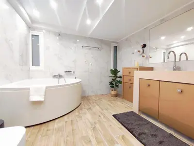 a white bathroom with a tub and a sink at Villa Photerra, A Luxury familly Villa with pool in Koskinou