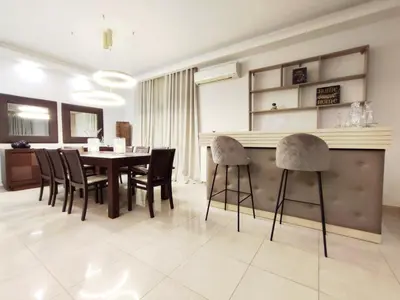 a dining room with a table and chairs at Villa Photerra, A Luxury familly Villa with pool in Koskinou