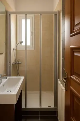 a bathroom with a shower and a sink at Villa Photerra, A Luxury familly Villa with pool in Koskinou