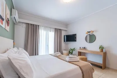 a hotel room with a bed and a mirror at Residence City Luna in Rhodes Town