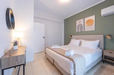 a hotel room with a bed and a desk at Residence City Luna in Rhodes Town