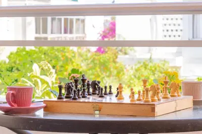a chess set on a table next to a window at Residence City Luna in Rhodes Town