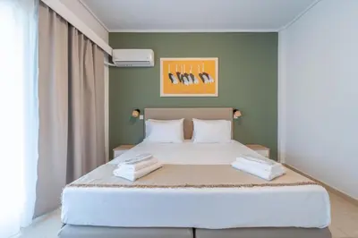 a bedroom with a bed with two towels on it at Residence City Frida in Rhodes Town