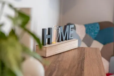 a wooden block with the word fame sitting on a table at Residence City Frida in Rhodes Town