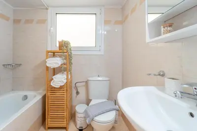 a bathroom with a tub and a toilet and a sink at Residence City Frida in Rhodes Town