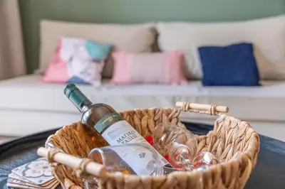 a basket with a bottle of wine and glasses on a table at Residence City Frida in Rhodes Town