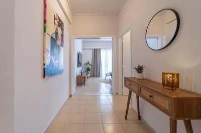 a hallway with a dresser and a mirror on a wall at Residence City Frida in Rhodes Town