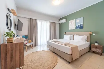 a hotel room with a large bed and a table at Residence City Frida in Rhodes Town