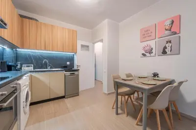 a kitchen and dining room with a table and chairs at Residence City Retreat in Rhodes Town