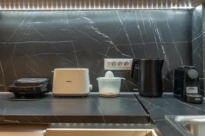 a kitchen counter with various appliances on a counter top at Residence City Retreat in Rhodes Town