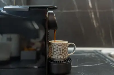 a coffee maker pouring coffee into a coffee cup at Residence City Retreat in Rhodes Town