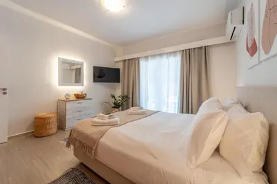 a bedroom with a large white bed with a window at Residence City Retreat in Rhodes Town