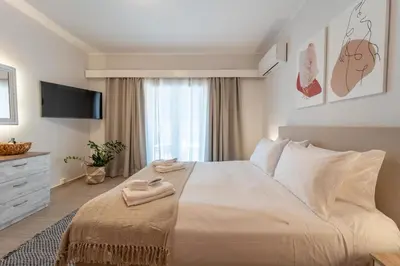 a bedroom with a large bed with towels on it at Residence City Retreat in Rhodes Town