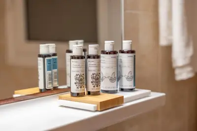 a shelf with four bottles of hair products on it at Residence City Retreat in Rhodes Town