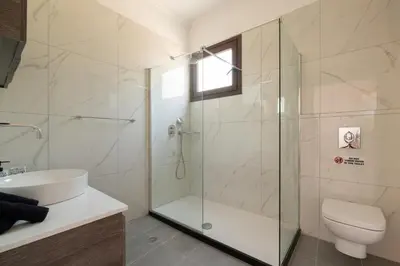 a bathroom with a shower and a toilet and a sink at Anthi Luxury Residence in Triánta