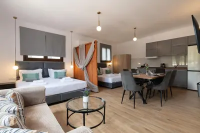 a hotel room with a bed and a dining room at Anthi Luxury Residence in Triánta