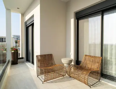 two rattan chairs sitting on a balcony at Casa di Anna Seaside in Rhodes Town