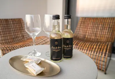 two bottles of wine on a table with wine glasses at Casa di Anna Seaside in Rhodes Town
