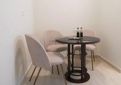 a black table with chairs and wine bottles on it at Casa di Anna Seaside in Rhodes Town