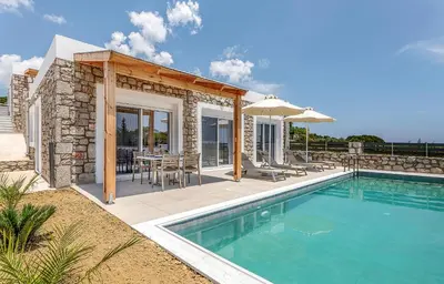 a house with a swimming pool and a patio at Gennadi GEMS Villas in Gennadi