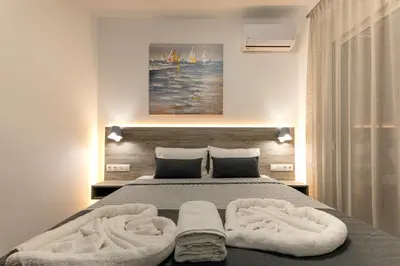 a bedroom with a bed with two towels on it at Gennadi GEMS Villas in Gennadi