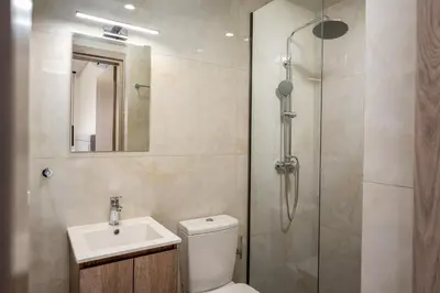 a bathroom with a shower and a toilet and a sink at Central Avenue Studios in Kremasti