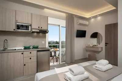 a kitchen with towels on a bed in a room at Central Avenue Studios in Kremasti