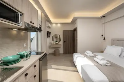 a kitchen with two beds in a room at Central Avenue Studios in Kremasti