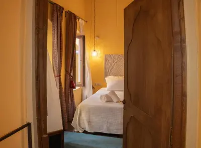 a bedroom with a bed and a door leading into a room at Ottoman's Manor in Rhodes Town