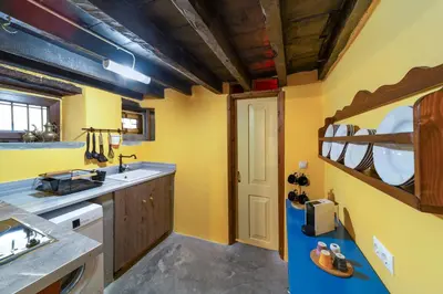a kitchen with yellow walls and a blue counter at Ottoman's Manor in Rhodes Town
