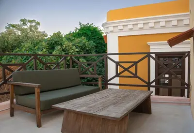 a wooden table and a bench on a balcony at Ottoman's Manor in Rhodes Town