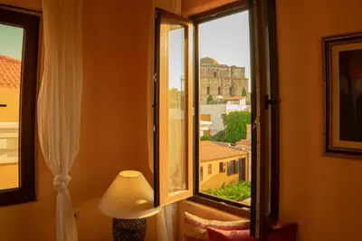 a room with a window with a view of a building at Ottoman's Manor in Rhodes Town