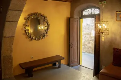 a hallway with a bench and a mirror on the wall at Ottoman's Manor in Rhodes Town