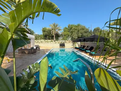 a swimming pool in a yard with plants at Villa Splendide in Rhodes Town