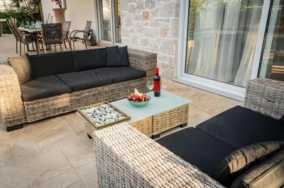 a patio with a couch and chairs and a table at Villa Splendide in Rhodes Town