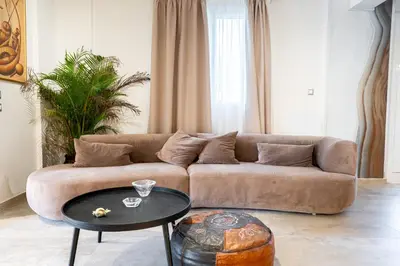 a living room with a couch and a table at Villa Splendide in Rhodes Town