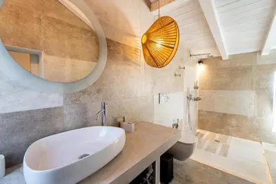 a bathroom with a sink and a toilet and a mirror at Villa Splendide in Rhodes Town